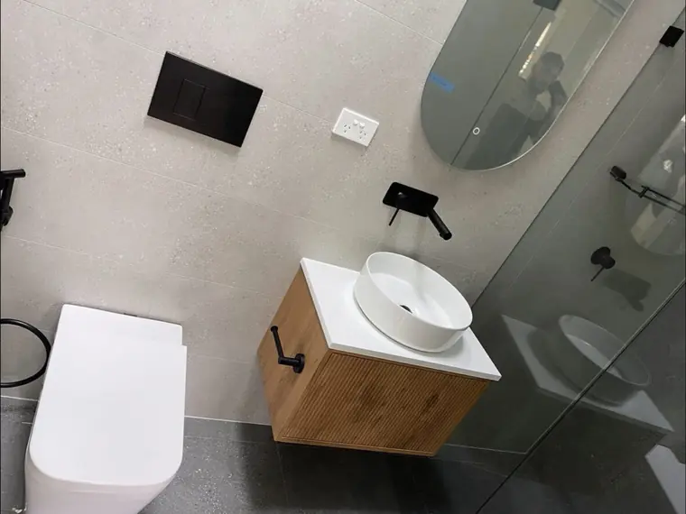 Completed modern bathroom renovation with wall-hung vanity and concealed cistern