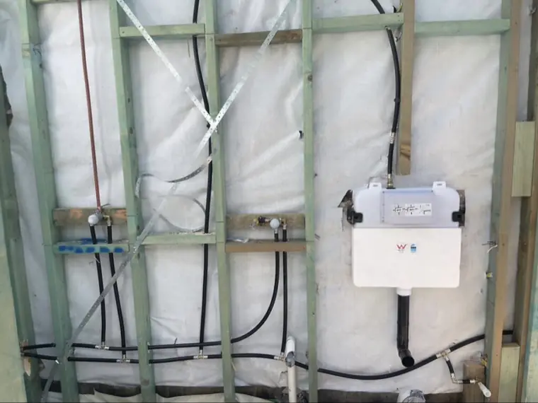 Water and gas rough-in through wall framing with concealed cistern installed