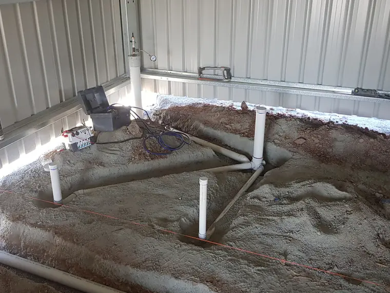 Plumbing set out through a prepared slab area on a new build