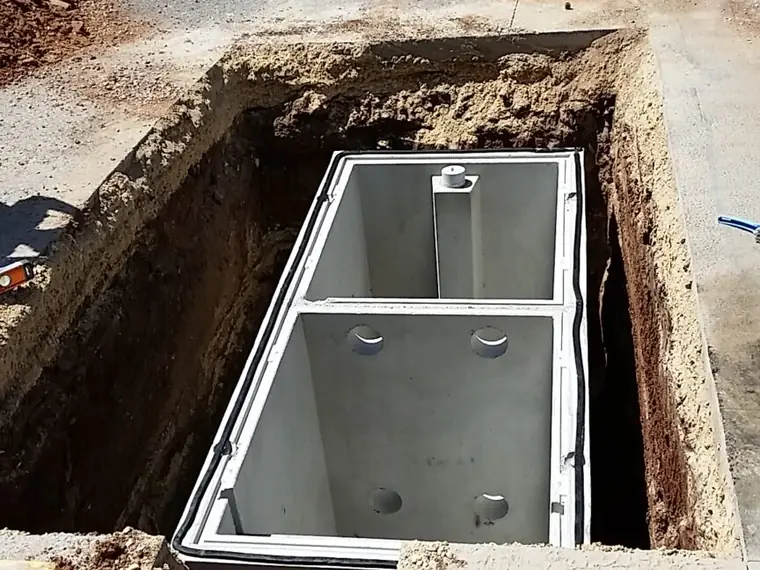 Concrete stormwater pit being installed in an excavated trench