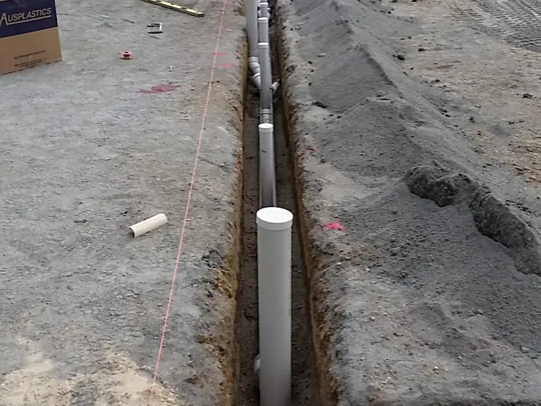 Sewer line laid and bedded in an excavated trench on a construction site