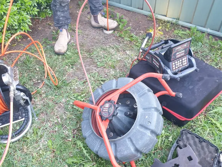 Drain clearing and jetting equipment laid out at a Sydney property