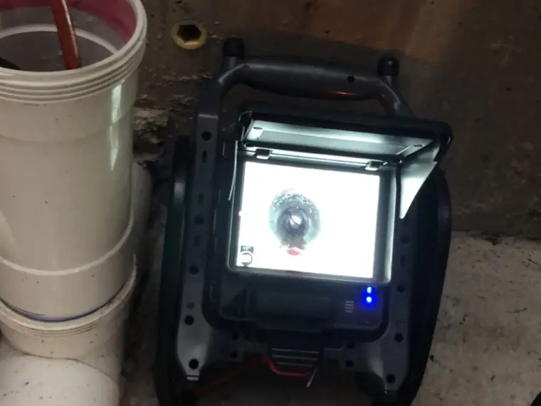 Drain camera reel and monitor set up for a pipe inspection