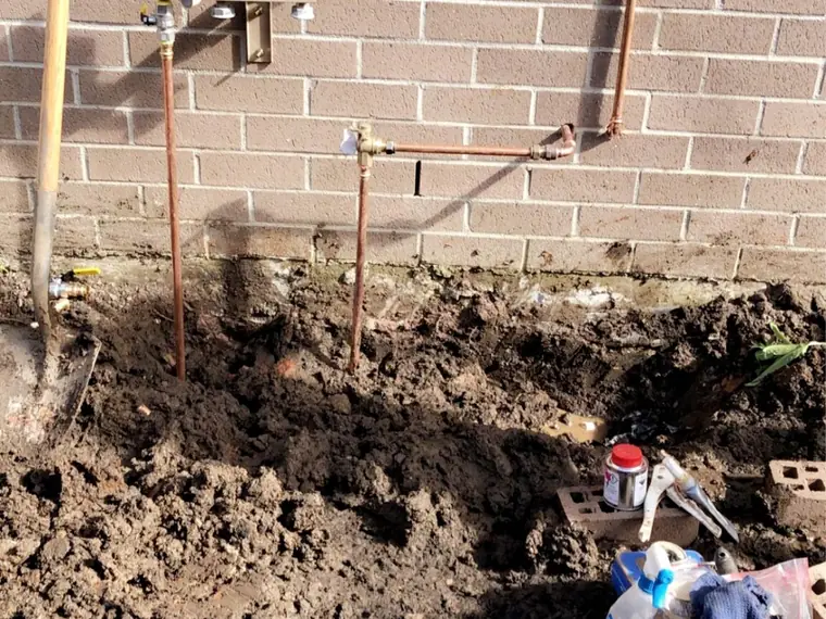New gas line run in copper along a brick wall to a meter