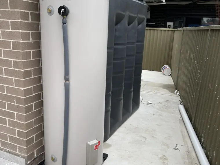 New hot water storage unit installed to the side of a home